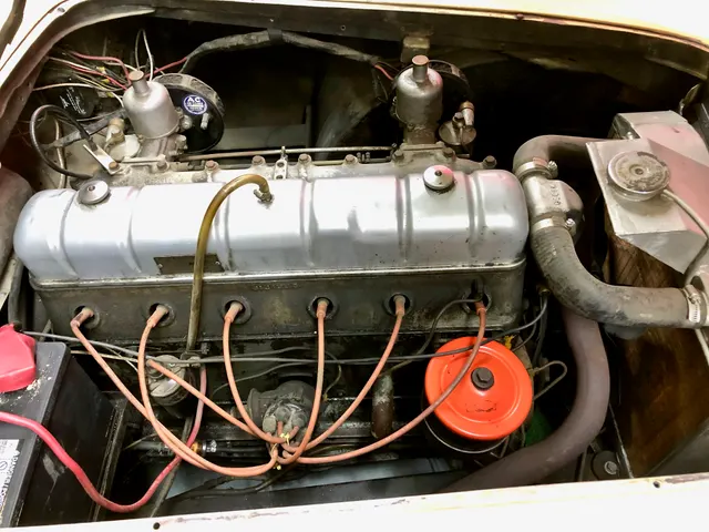 Exact-year engine-bay view showing the Nash inline-six installation and twin-carburetor induction; restoration details and service parts remain car-specific.