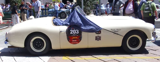 Side profile of the same 1951 roadster showing the 102-inch wheelbase, aluminum body, three-seat cockpit, and first-series proportions.