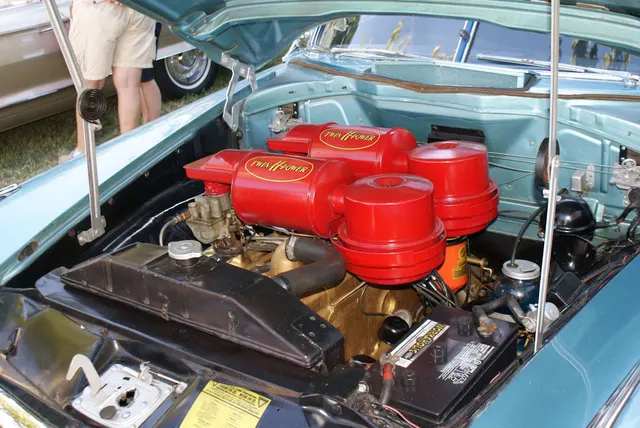 Exact-year engine bay showing a restored Hudson 308 with Twin H-Power induction; finish, battery, hoses, and service details remain subject-specific.