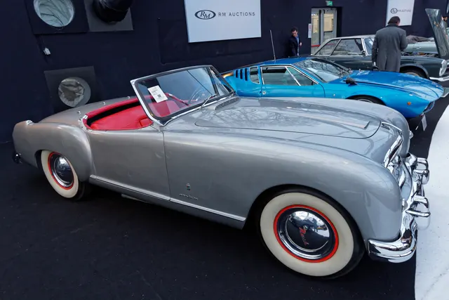 Side and front three-quarter view of an exact-year roadster showing its predominantly steel Pinin Farina body and 102-inch-wheelbase stance.