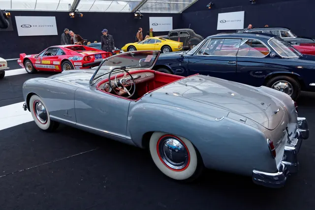 Rear three-quarter view showing the 1952 roadster tail, deck lid, lamps, bumpers, cockpit, dashboard, and body-side script.