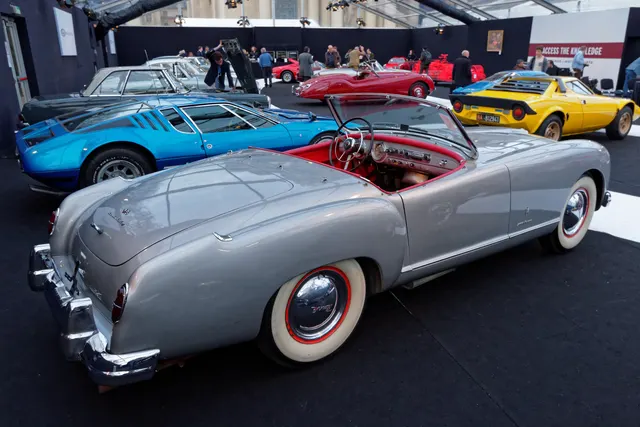Elevated rear three-quarter view retained for white paint, red cabin trim, brightwork, wheel, and body-seam context; finish and condition remain car-specific.