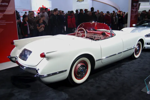 Rear three-quarter view of an exact-year Corvette showing the rear body, integrated exhaust outlets, cockpit, and wheel treatment.