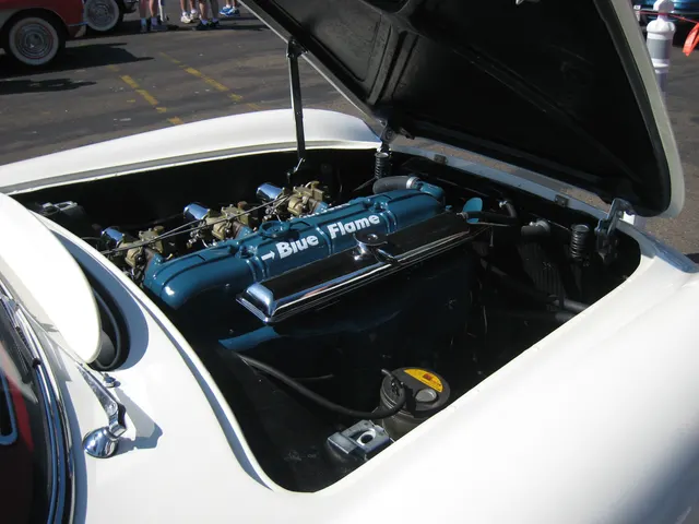 Restored 1953 Corvette Blue Flame engine bay showing the inline-six and triple Carter side-draft carburetor installation; individual component originality still requires inspection.