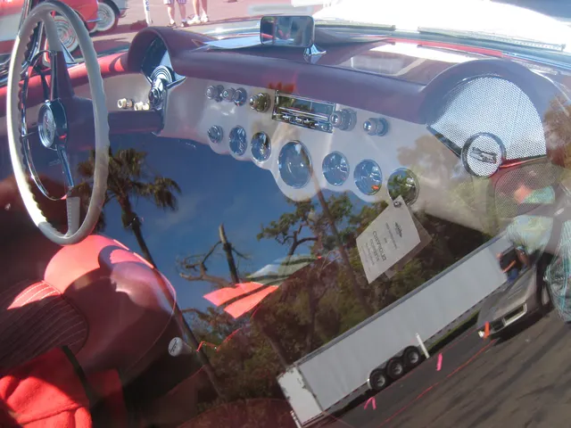 Dashboard detail from an exact-year restored Corvette showing the instruments, steering wheel, radio, heater controls, and Powerglide selector.
