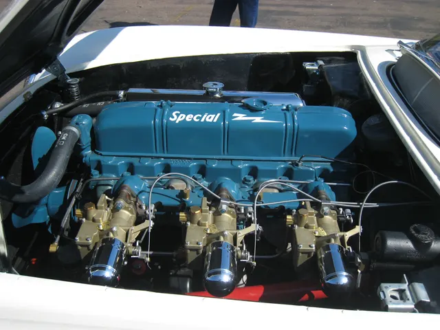 Closer view of a restored 1953 Blue Flame Six and its triple side-draft carburetor hardware; the photograph does not establish date correctness for another car.