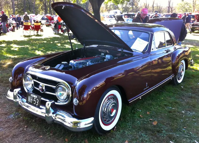 Front three-quarter view of a 1953 Le Mans hardtop showing the Pinin Farina roof, longer 108-inch-wheelbase body, grille, and hardtop glazing.