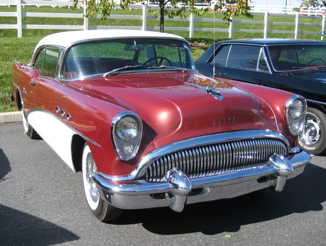 Exact-year view retained for two-tone paint, bright side trim, glazing, lamps, bumpers, and wheel context; finish and restoration condition remain car-specific.