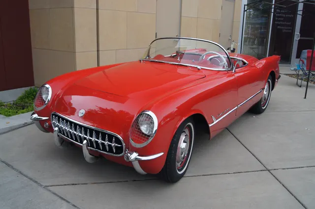 Sportsman Red 1954 Corvette showing the production body shape, chrome grille and bumpers, red cockpit, and wheel treatment.
