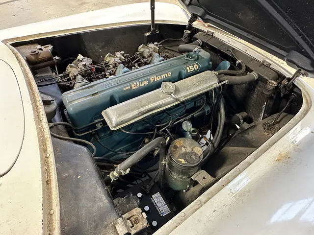 Exact-year restored engine bay showing the 235.5-cubic-inch Blue Flame Six and triple Carter side-draft induction; casting, stamping, date, and restoration evidence remain necessary for an individual car.