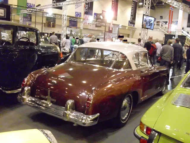 Opposite front three-quarter view of the same exact-year coupe retained for roof, glazing, body contour, grille, lighting, wheels, and trim inspection context.