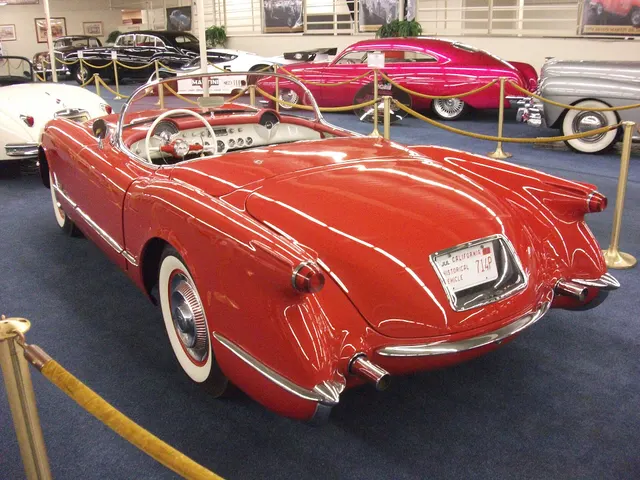 Rear three-quarter view showing the three-piece bumper, tail lamps, trunk contour, rear body trim, and through-body dual exhaust outlets of a V8 car.