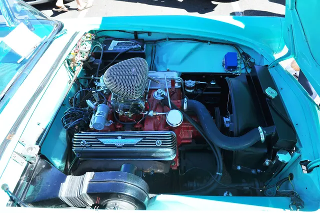 Restored 1955 Thunderbird engine bay showing a 292 Y-block installation; carburetor, electrical, finish, fastener, and date correctness remain specific to the photographed car.