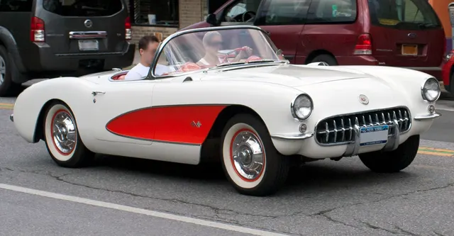 Polo White 1956 Corvette with red coves in front three-quarter view, showing another documented factory color treatment and the open cockpit.