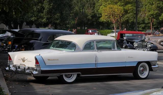 1956 Caribbean hardtop rear three-quarter view showing the roof profile, rear paint break, twin antennas, and cathedral taillamps