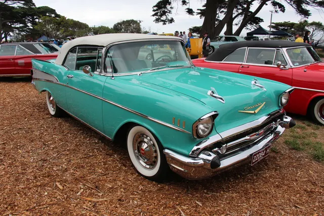 Bel Air convertible showing the open five-passenger body, windshield, top well, rear-quarter insert, and model-year exterior details.
