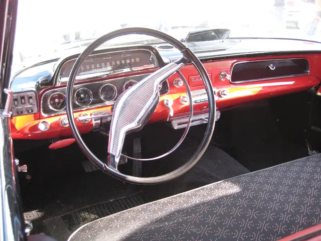 Exact-year Coronet cabin retained for the instrument cluster, push-button transmission selector, steering wheel, dashboard controls, glovebox, pedals, and front-seat upholstery of the photographed car.