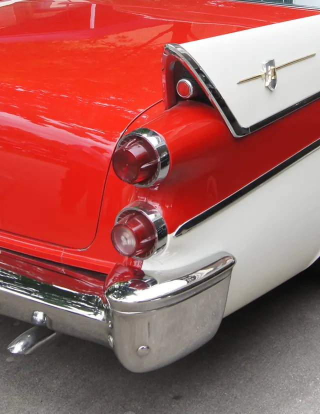 Exact-year Coronet Lancer rear-quarter detail retained for fin insert, emblem, stacked lamp lenses, body-side color boundary, moldings, bumper, and protected-finish inspection context.