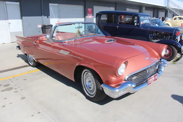 Open-car front profile showing model-year body lines, fender trim, wheel covers, grille, and bumper.