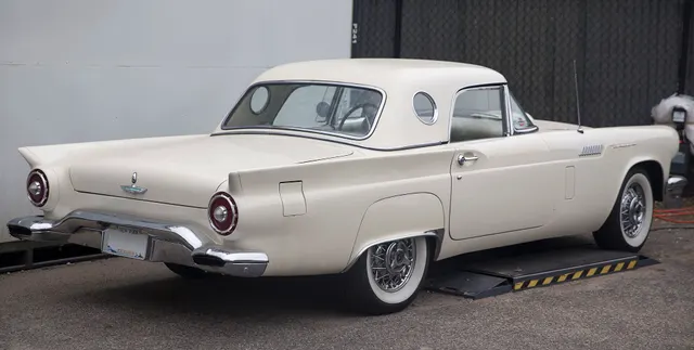 Restored-stock rear three-quarter view with the porthole hardtop installed; current finishes remain car-specific.