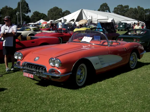Signet Red 1958 Corvette roadster in front three-quarter view with factory-style wheel covers and whitewalls.