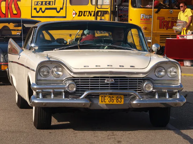 Exact-year Coronet hardtop front view retained for the grille, quad lamps, bumper, hood letters, windshield, mirrors, fin edges, and front stance; accessories and finish remain specific to the photographed car.