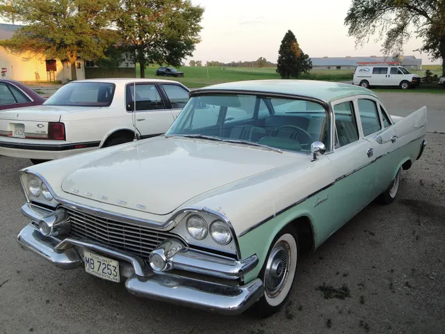 Exact-year Coronet four-door sedan retained for the front sheet metal, grille, quad lamps, hood letters, windshield, roof, side molding, Coronet script, wheel covers, whitewalls, and unrestored condition context.