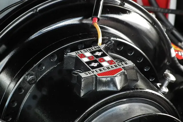 Close view of the restored Jet Stream centrifugal supercharger retained for component identification context; tags, finishes, and hardware remain subject-specific.