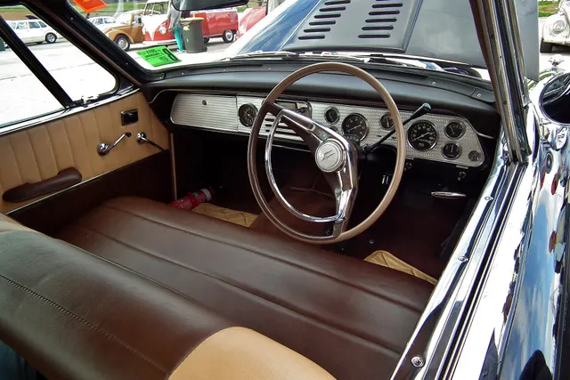 Exact-year restored Golden Hawk cabin retained for dashboard, instruments, steering wheel, seating, door trim, and automatic-control context; finishes remain car-specific.