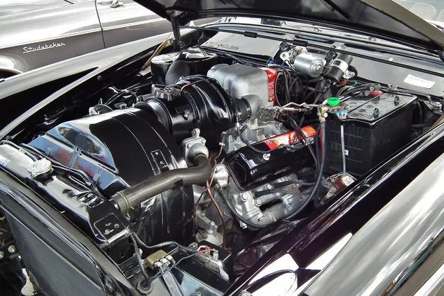 Exact-year restored Golden Hawk engine compartment showing the supercharged 289 installation; finishes, service parts, and individual originality remain car-specific.