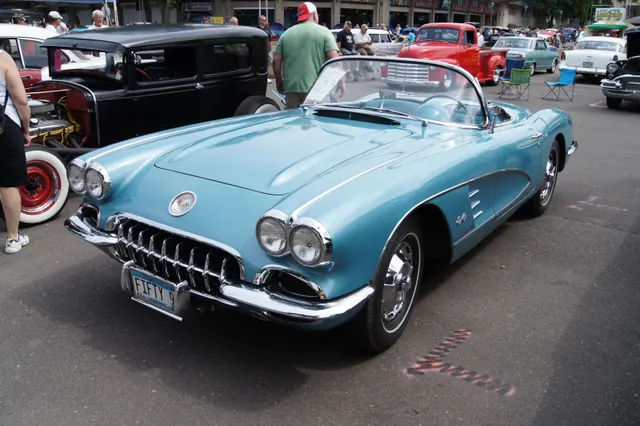 Frost Blue 1959 Corvette roadster in front three-quarter view, showing the open cockpit, coves, and factory-style wheel covers.