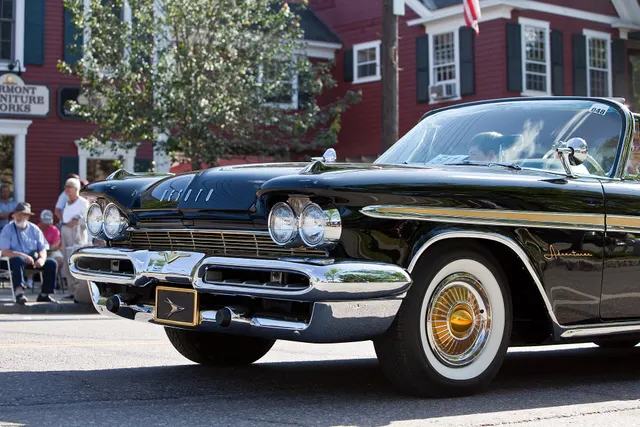 Exact-model convertible front detail showing the shared grille, headlamps, bumper openings, gold sweep, Adventurer script, and gold wheel cover.