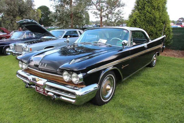 Second exact-model hardtop view showing the 1959 hood, grille, bumper openings, gold side insert, Adventurer script, roof treatment, and factory-style wheel covers.