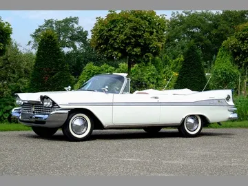 Exact-year stock-presenting view retained for body, trim, glass, lamp, bumper, and wheel context; condition and restoration details remain specific to the photographed car.