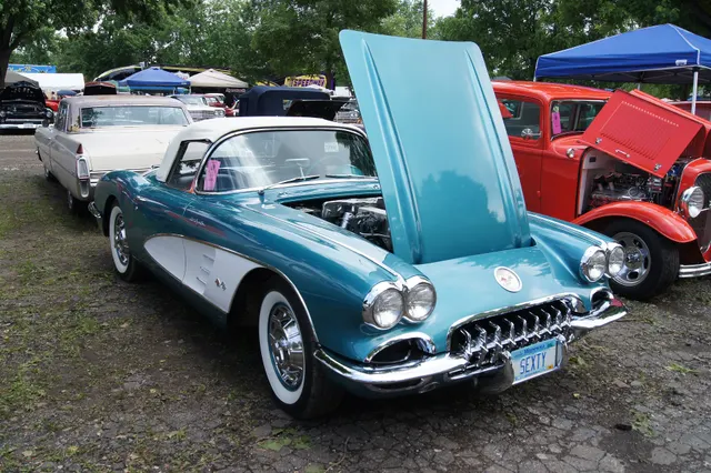 Tasco Turquoise 1960 Corvette with Ermine White coves and hardtop, shown hood-up for exterior and engine-bay context.