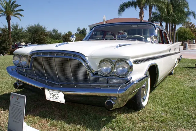 Exact-model four-door hardtop front view showing the pillarless four-door greenhouse, shared nose, side molding, fin profile, and factory-style wheels.