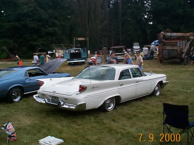 Four-door sedan rear three-quarter view showing the pillared greenhouse, fin and tail-lamp treatment, deck, bumper, and body-side proportions.