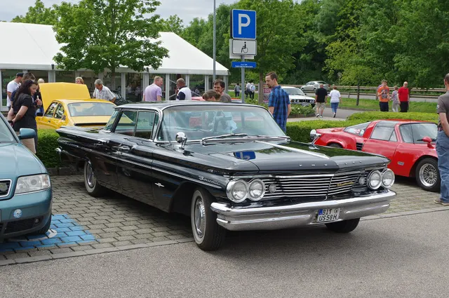 Exact-year stock-presenting view retained for body, trim, glass, lamp, bumper, and wheel context; condition and restoration details remain specific to the photographed car.