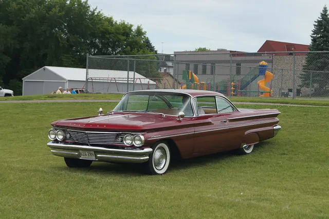 Exact-year stock-presenting view retained for body, trim, glass, lamp, bumper, and wheel context; condition and restoration details remain specific to the photographed car.