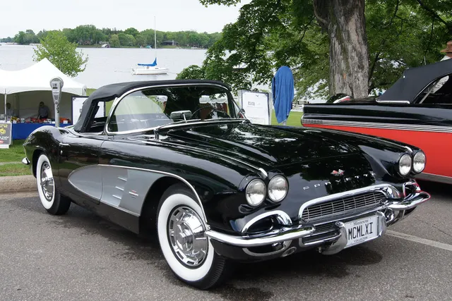 Alternate front view of the same stock-presenting Tuxedo Black 1961 Corvette, showing the cleaner grille and split bumpers.