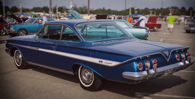 Exact-year Super Sport coupe rear three-quarter view retained for the bubble-top roof, rear glass, quarter trim, six-lamp rear treatment, SS and Impala identification, bumper, wheel covers, whitewalls, and stock-presenting stance; current condition remains car-specific.