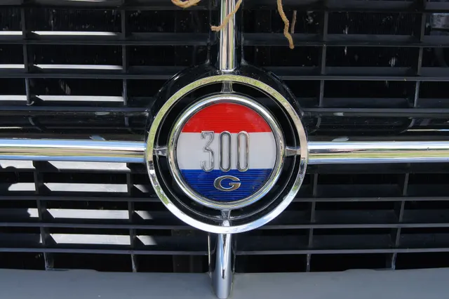 Close view of the 300G grille medallion retained for model-specific badge, finish, and mounting context.