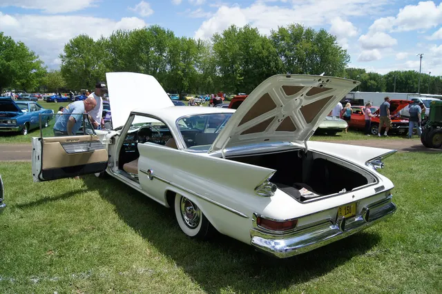 Hardtop rear three-quarter view with deck and doors open, retained for roof, fin, lamp, deck, body-opening, and trim inspection context.