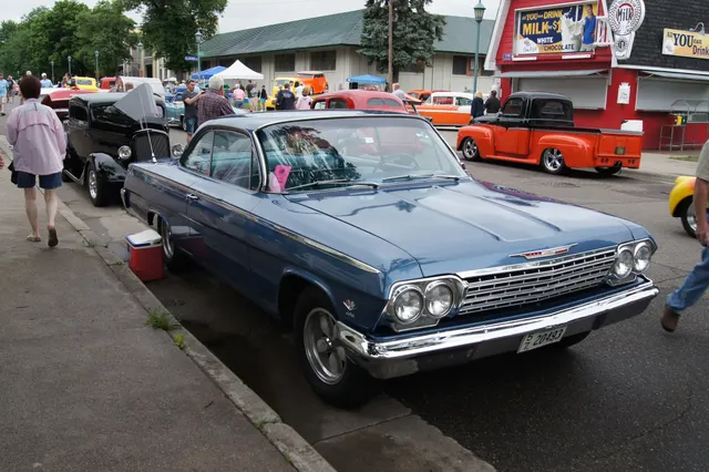 Blue 1962 Bel Air Sport Coupe with visible 409 fender emblem and later alloy wheels