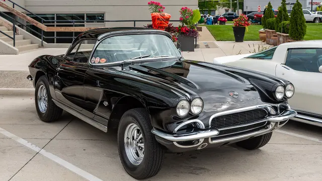Tuxedo Black 1962 Corvette in front three-quarter view; nonfactory wheels make this restoration context rather than an originality reference.