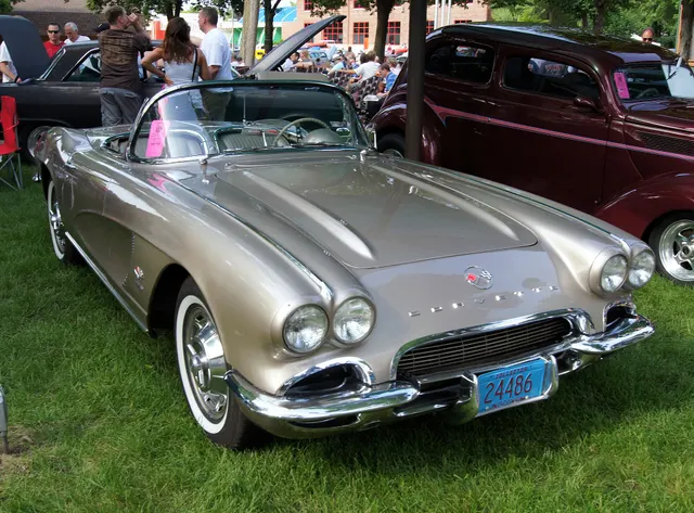 Sateen Silver 1962 Corvette showing the single cove louver, body-color cove, exposed headlamps, and model-year front trim.