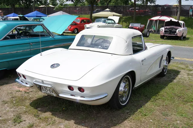 Ermine White 1962 Corvette in rear view with the soft top raised; retained as model-year and top-history context.