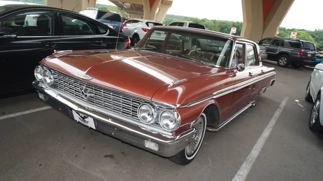 1962 Galaxie 500 four-door showing brown paint, side brightwork, grille, lamps, bumpers, and badging; body style, visible wheels, exhaust, condition, and restoration details remain specific to the photographed car.