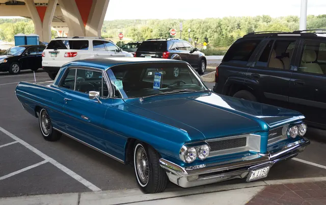 Exact-year stock-presenting view retained for body, trim, glass, lamp, bumper, and wheel context; condition and restoration details remain specific to the photographed car.