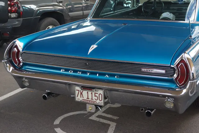 Exact-year stock-presenting view retained for body, trim, glass, lamp, bumper, and wheel context; condition and restoration details remain specific to the photographed car.